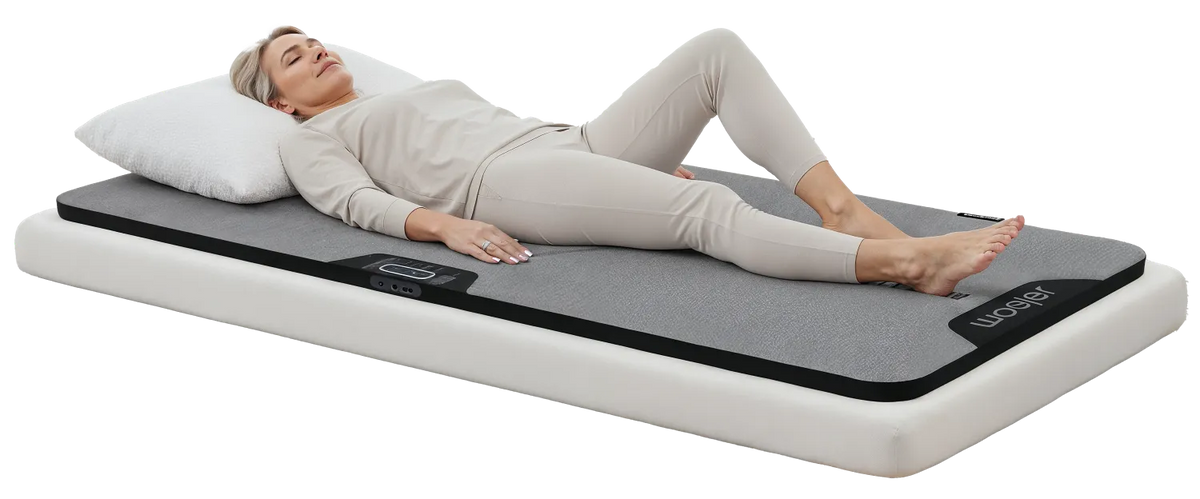A woman resting peacefully on the Woojer MAT
