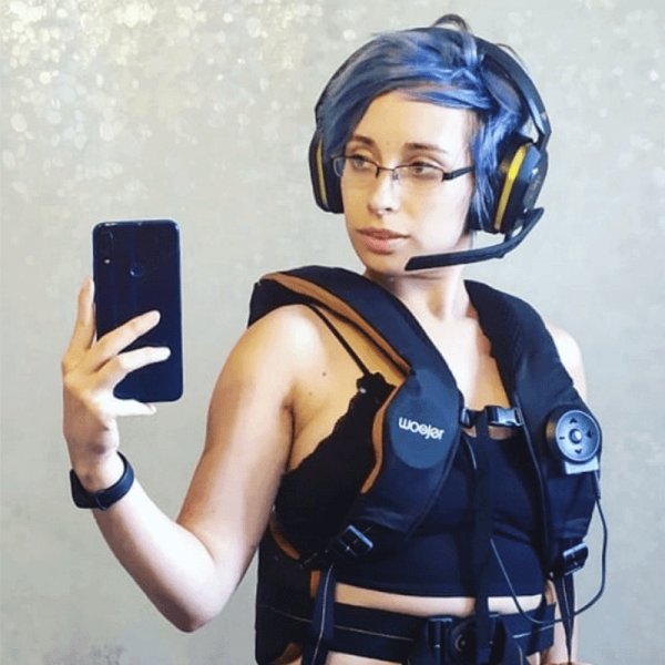 Customer wearing the Woojer Vest with a gaming headset