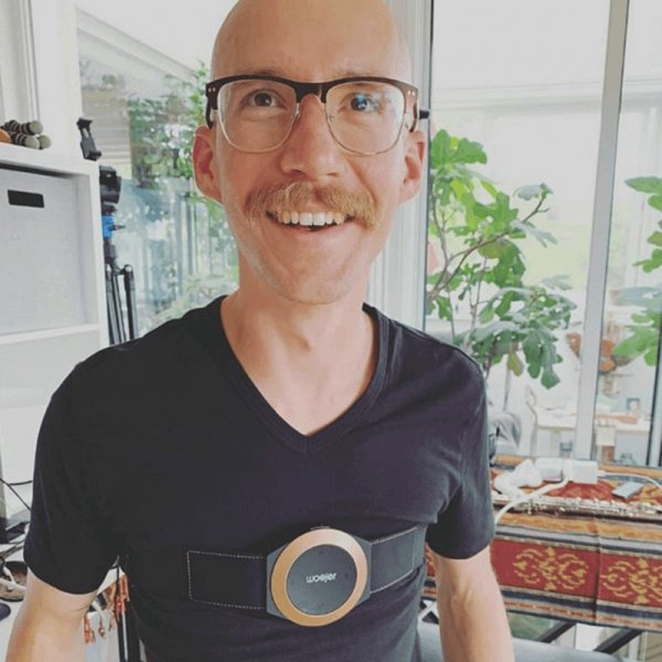 Woojer customer wearing the unit on his chest