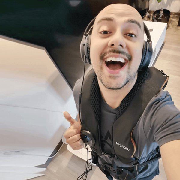 Woojer customer wearing headphones and the unit