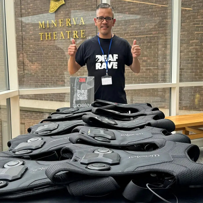 A row of Woojer Vests laid out at a Deaf Rave event