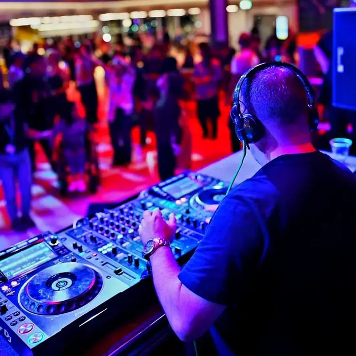 DJ wearing the Woojer Vest behind the decks