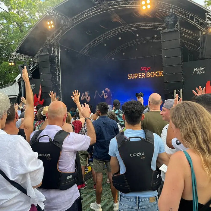 Crowd at an outdoor concert wearing Woojer Vests