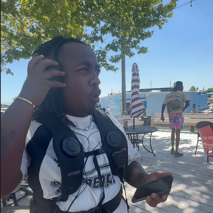Customer wearing the Woojer Vest by the sea