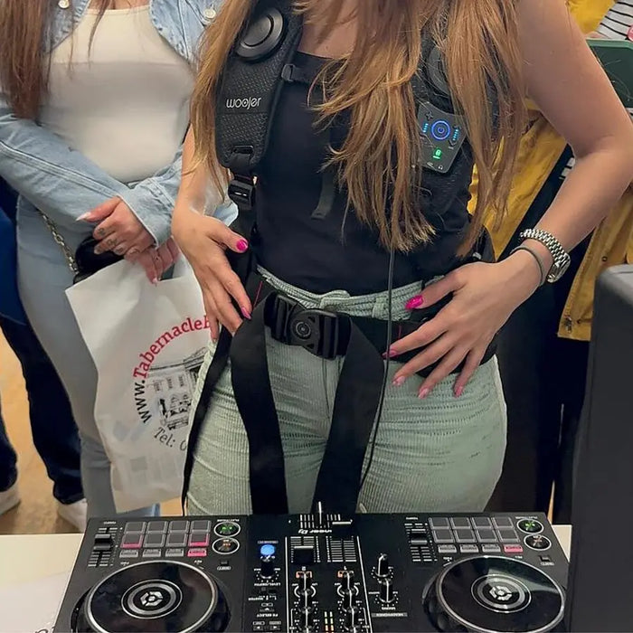 Customer wearing the Woojer Vest at a DJ setup