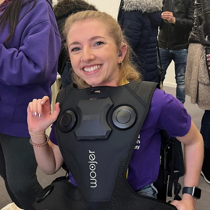 Customer smiling while wearing the Woojer Vest