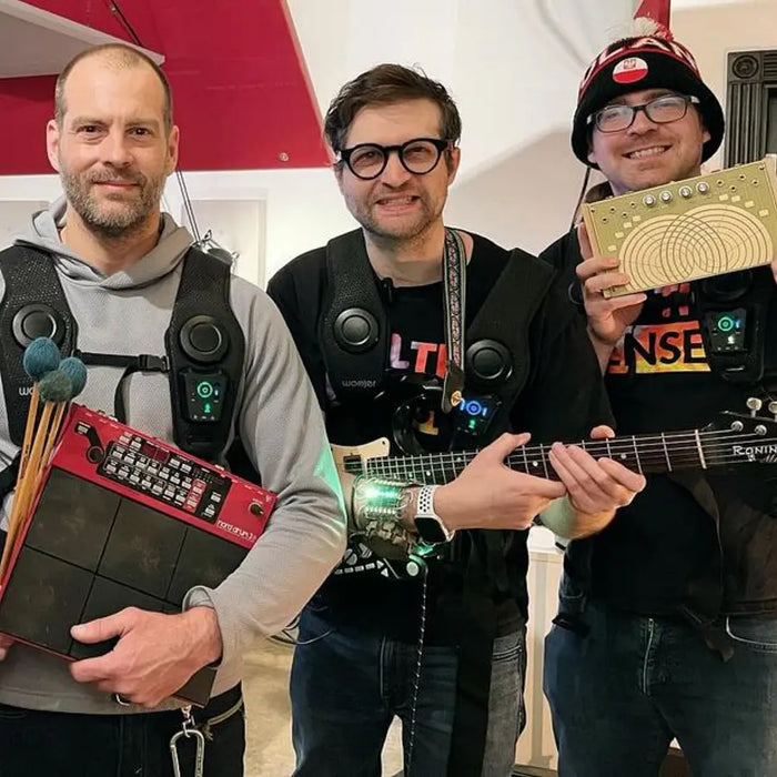 Three customers wearing Woojer Vests together